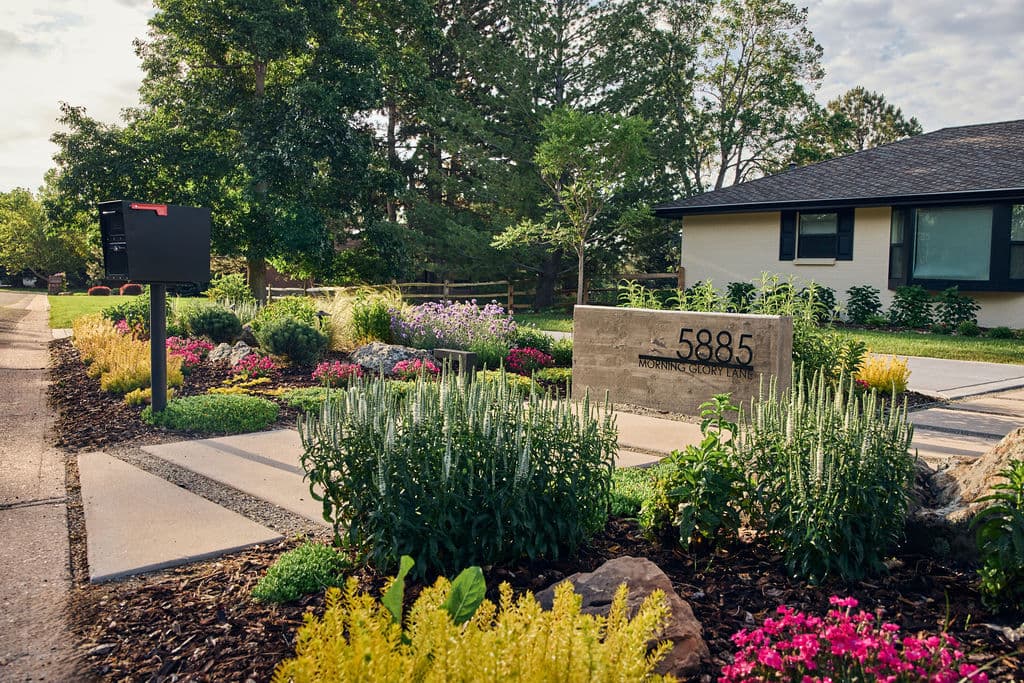 Modern home exterior with landscaped gardens and address 5885 clearly displayed.