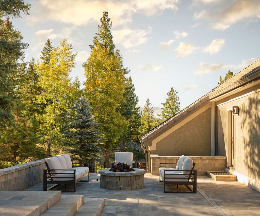Cozy outdoor seating area with firepit surrounded by trees and mountains, perfect for relaxation.