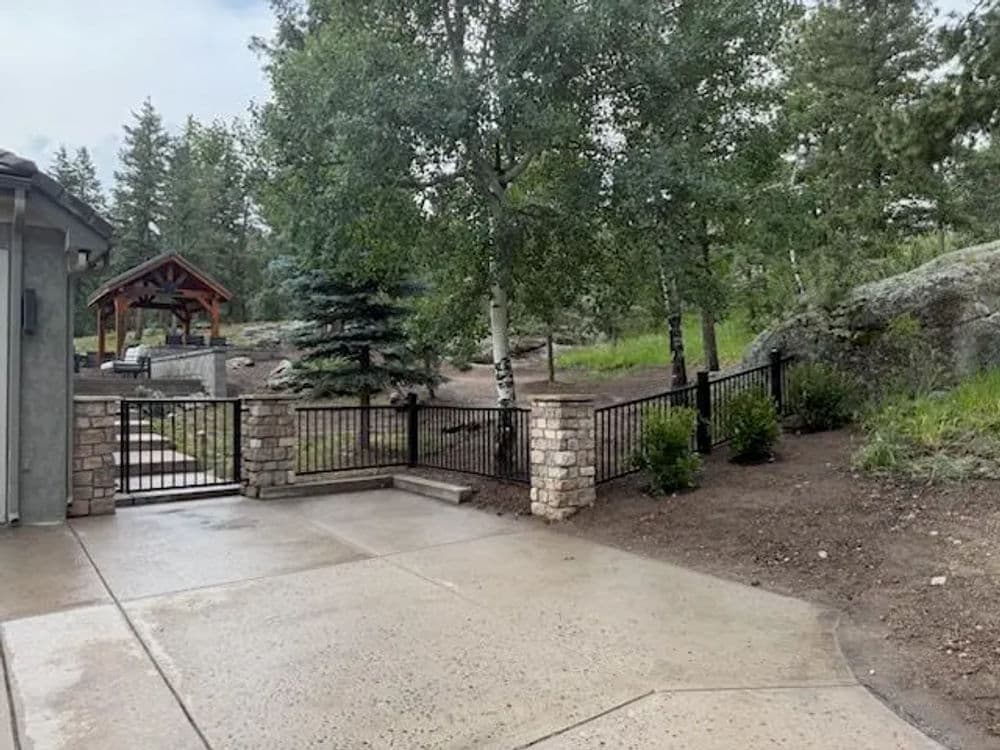 Serene outdoor space featuring a landscaped garden, stone pathway, and wooden gazebo.